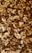 A close-up view of a variety of mixed nuts, including almonds, cashews, walnuts, and Brazil nuts. The assortment shows an appealing mixture of shapes, sizes, and textures, highlighting their natural tones and slightly oily surfaces.