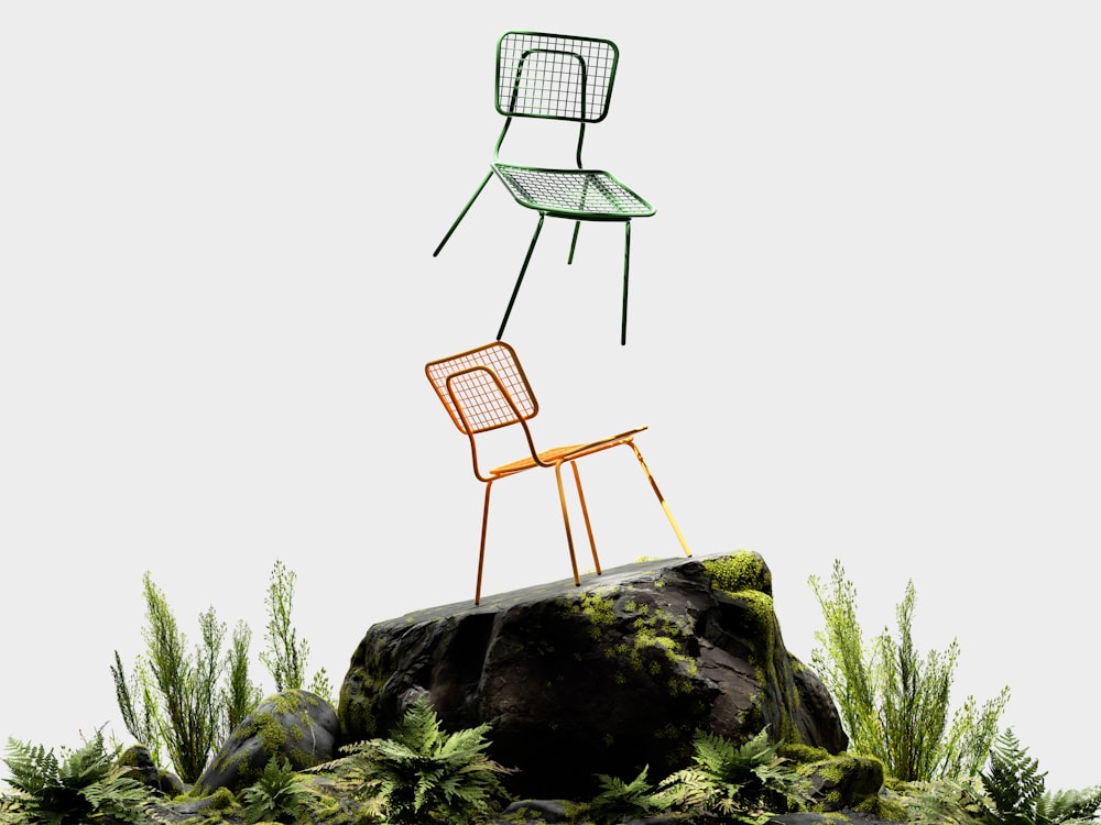 a couple of chairs sitting on top of a rock