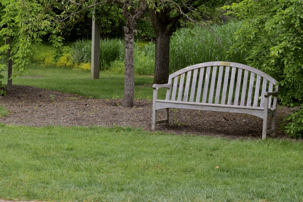 a wooden bench sitting in the middle of a park