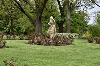 a statue of a woman in a garden