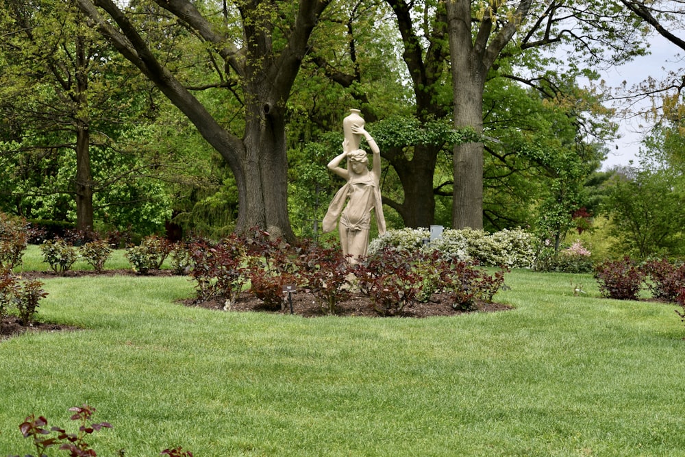 a statue of a woman in a garden