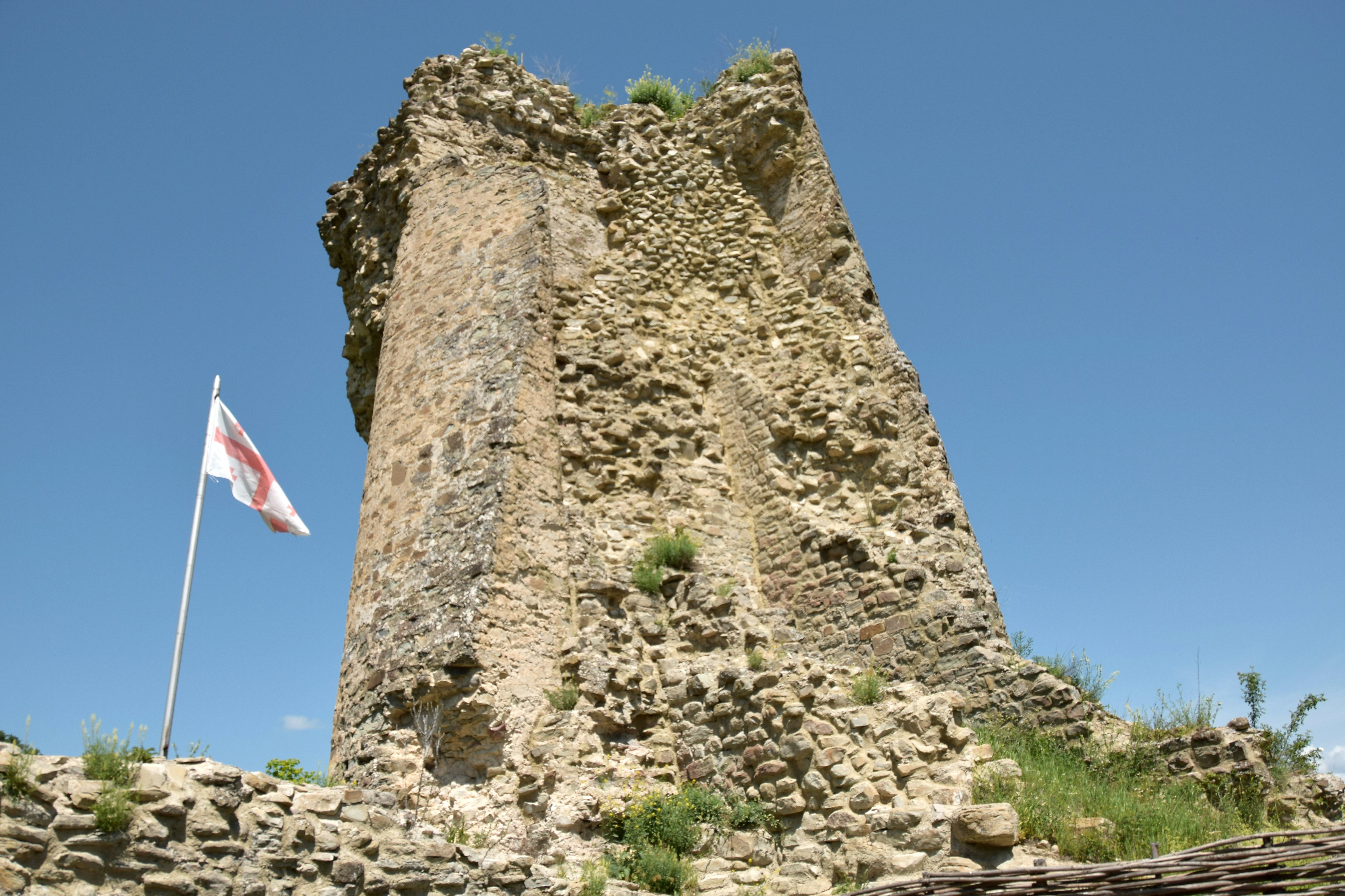 a tall tower with a flag on top of it
