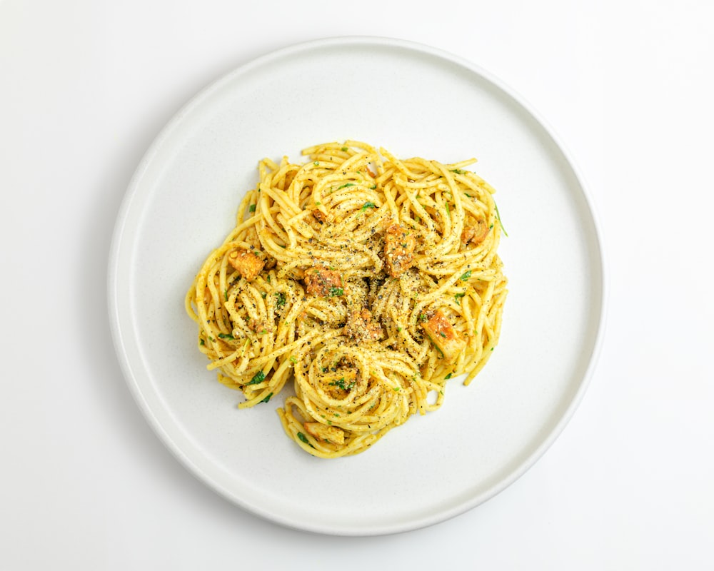 a white plate topped with a pasta dish