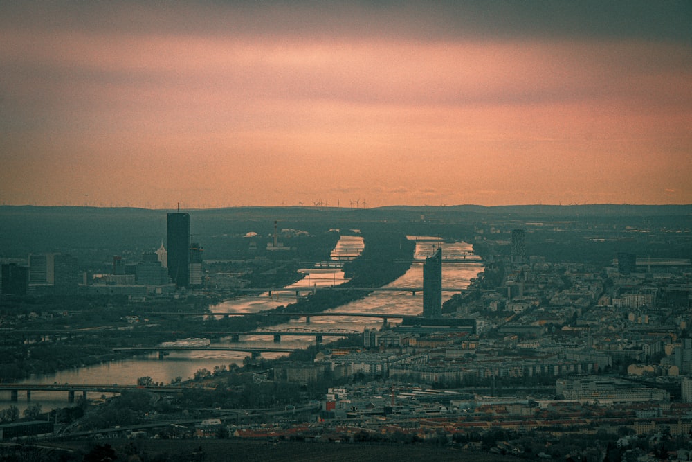 a river running through a city under a cloudy sky