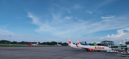 An aircraft parked on the tarmac with a clear blue sky overhead.