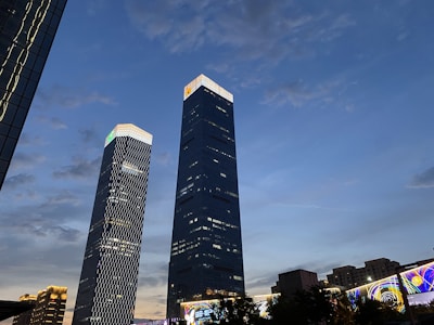 Elegant twilight view of Two Sudirman’s sleek towers illuminated against Jakarta’s night sky.