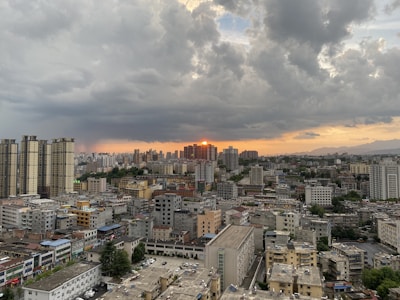 A cityscape view of New York and New Jersey apartment buildings at sunset.