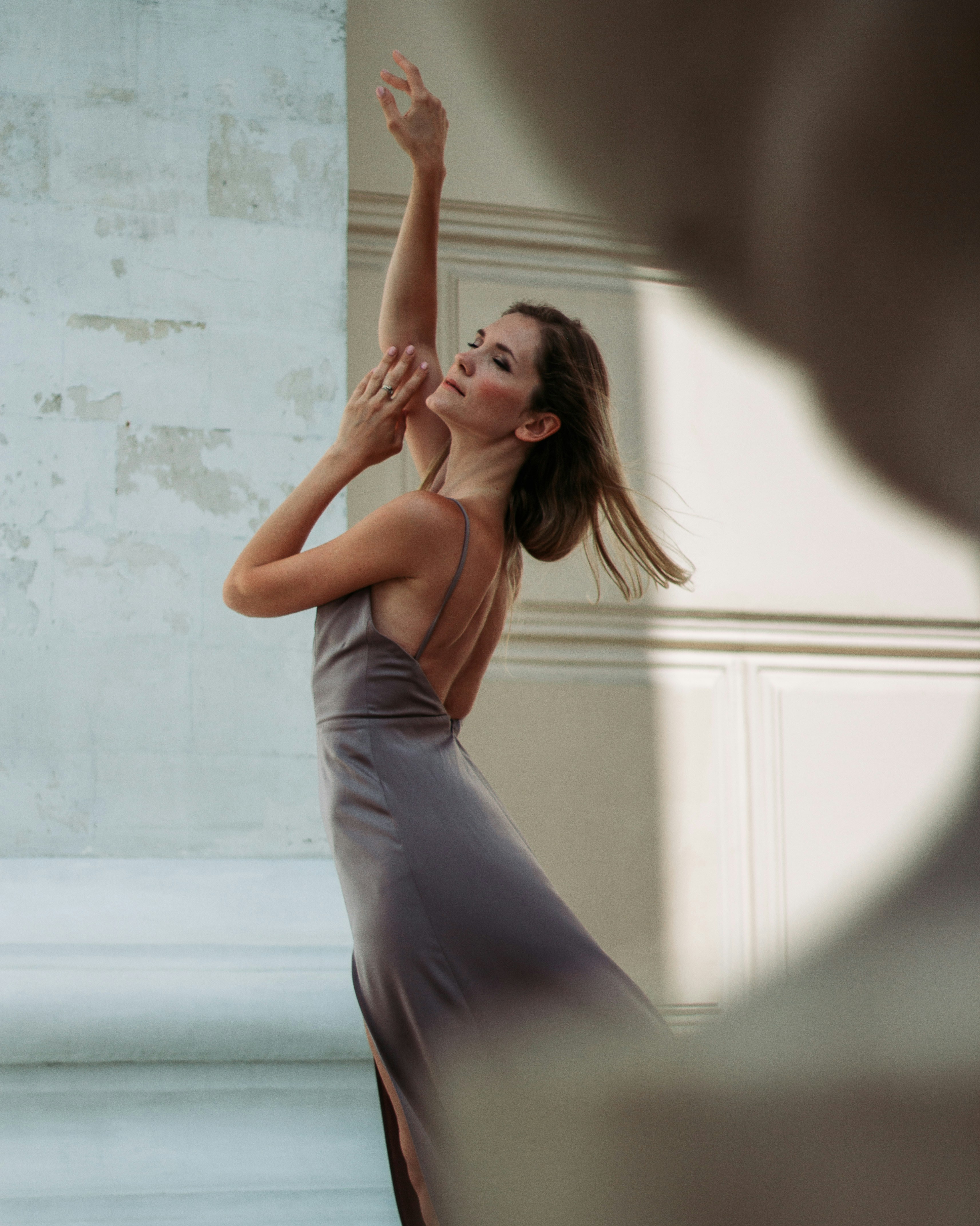 a woman in a gray dress is dancing