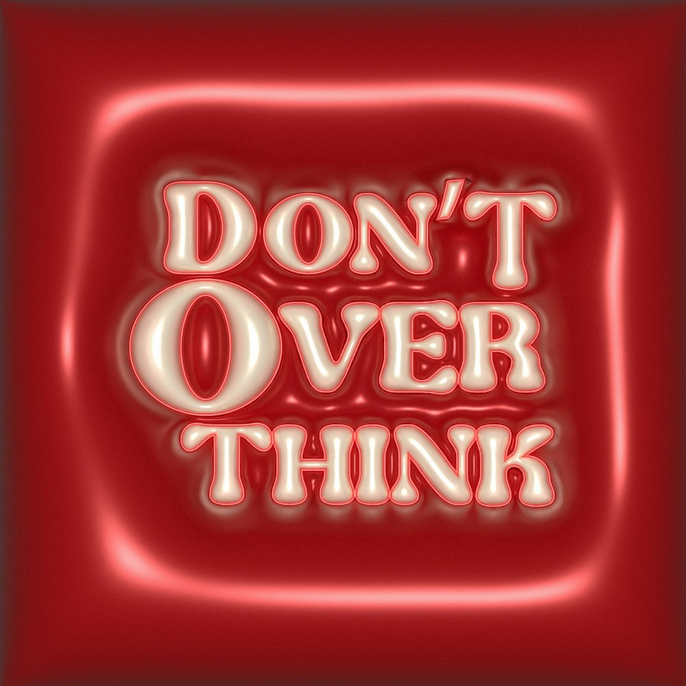 the words don't over think on a red background