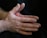 a person's hands with a black background