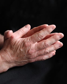 a close up of a person holding their hands together