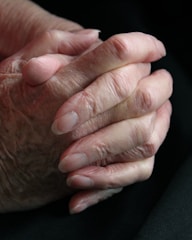 Close-up of elderly hands holding each other in solidarity