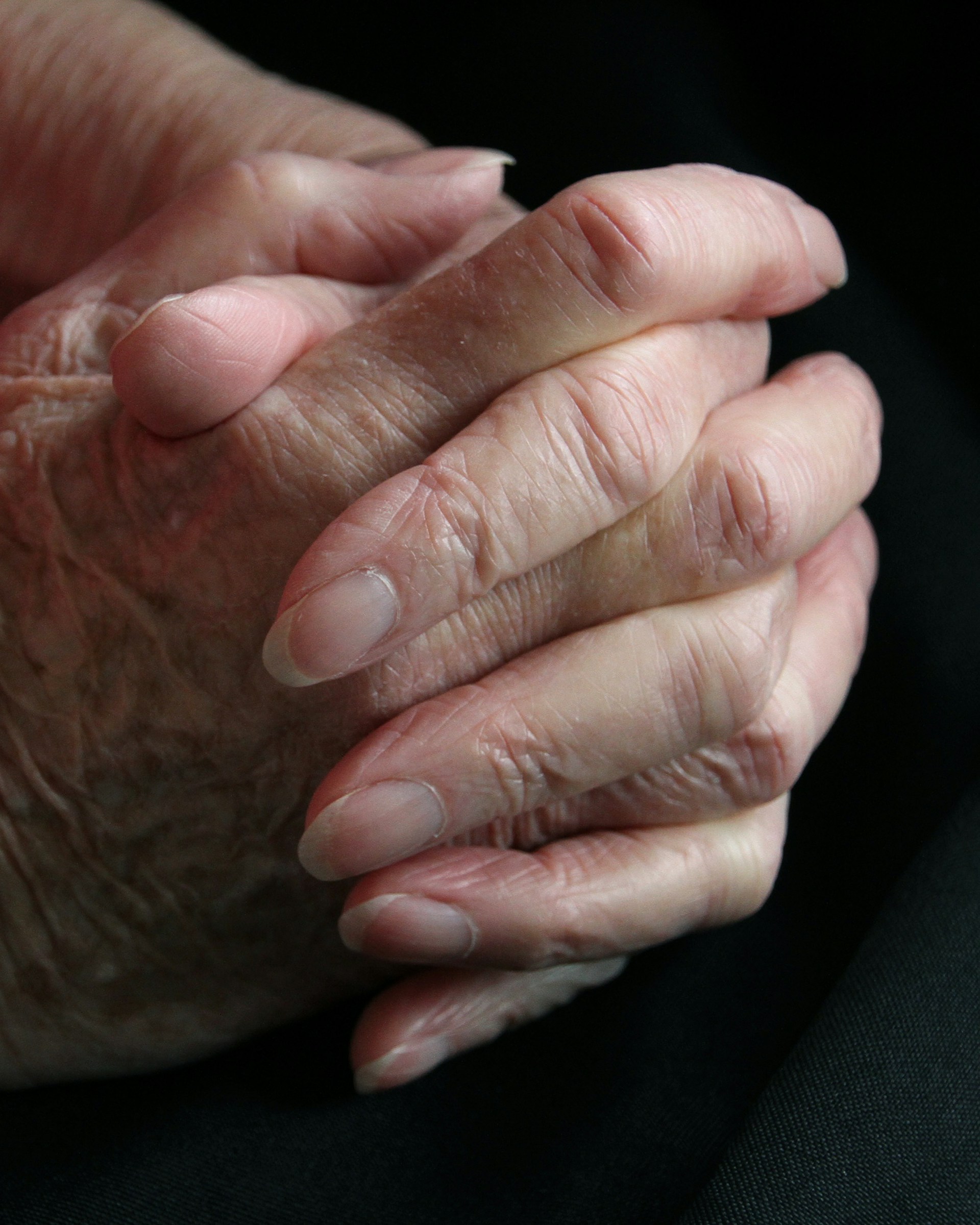 a close up of a person holding their hands together