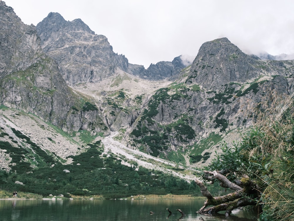 a body of water with mountains in the background