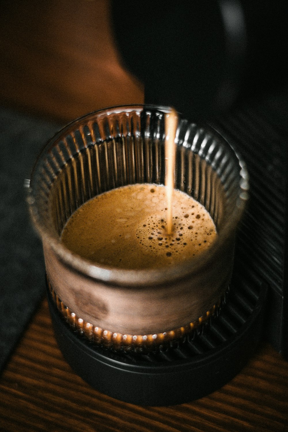 a cup of coffee being poured into it