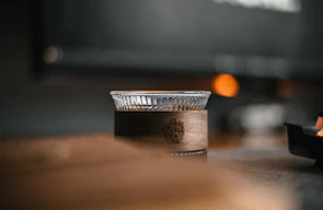 A unique personalized object resting on a wooden table, illuminated by soft natural light.