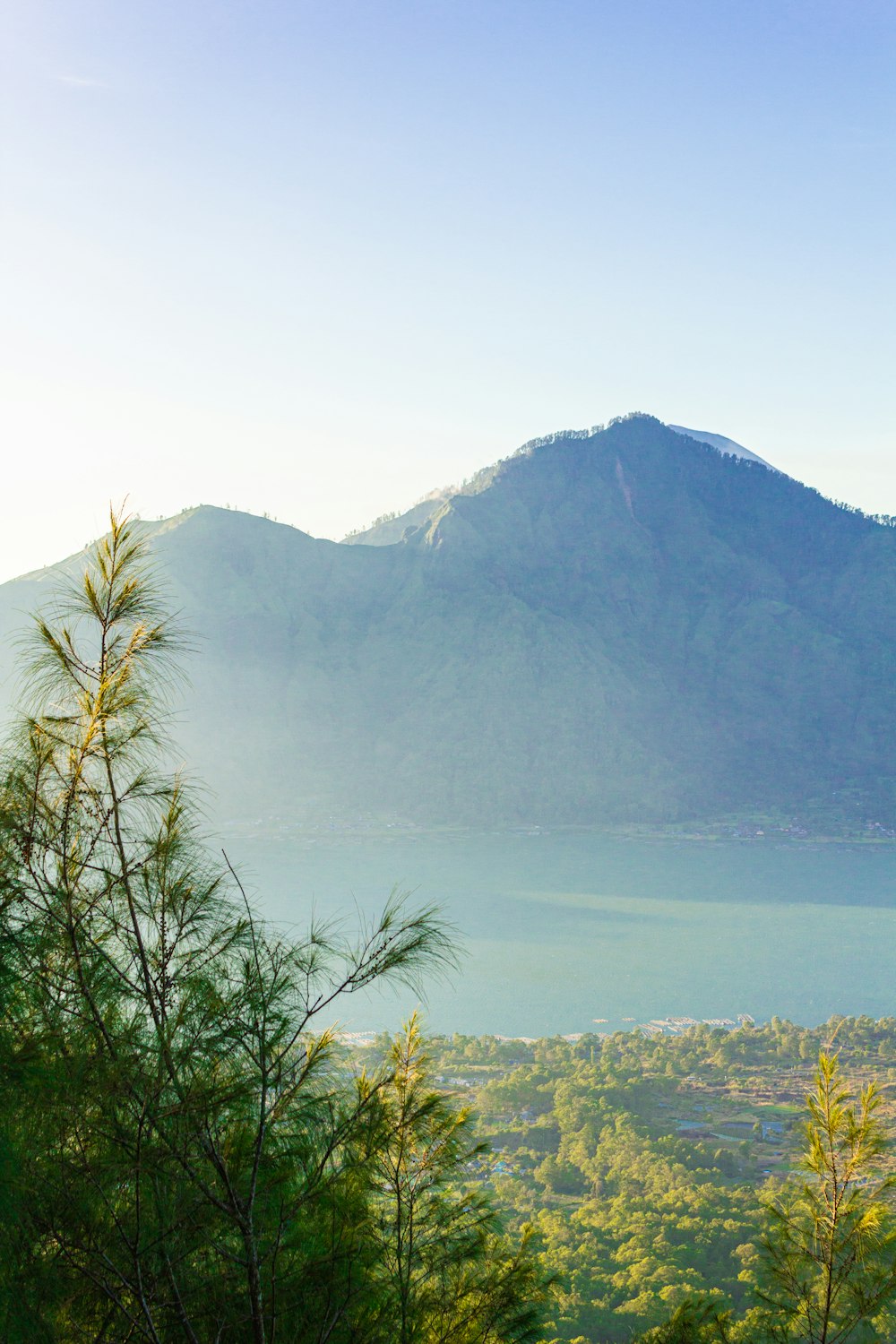 a view of a mountain with a lake in the foreground