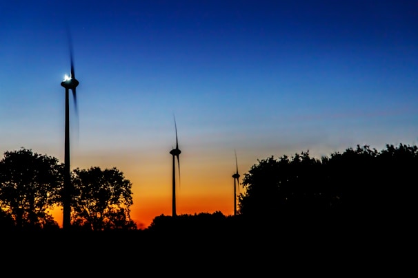 Close-up of a wind turbine blade spinning gracefully against a sunset backdrop