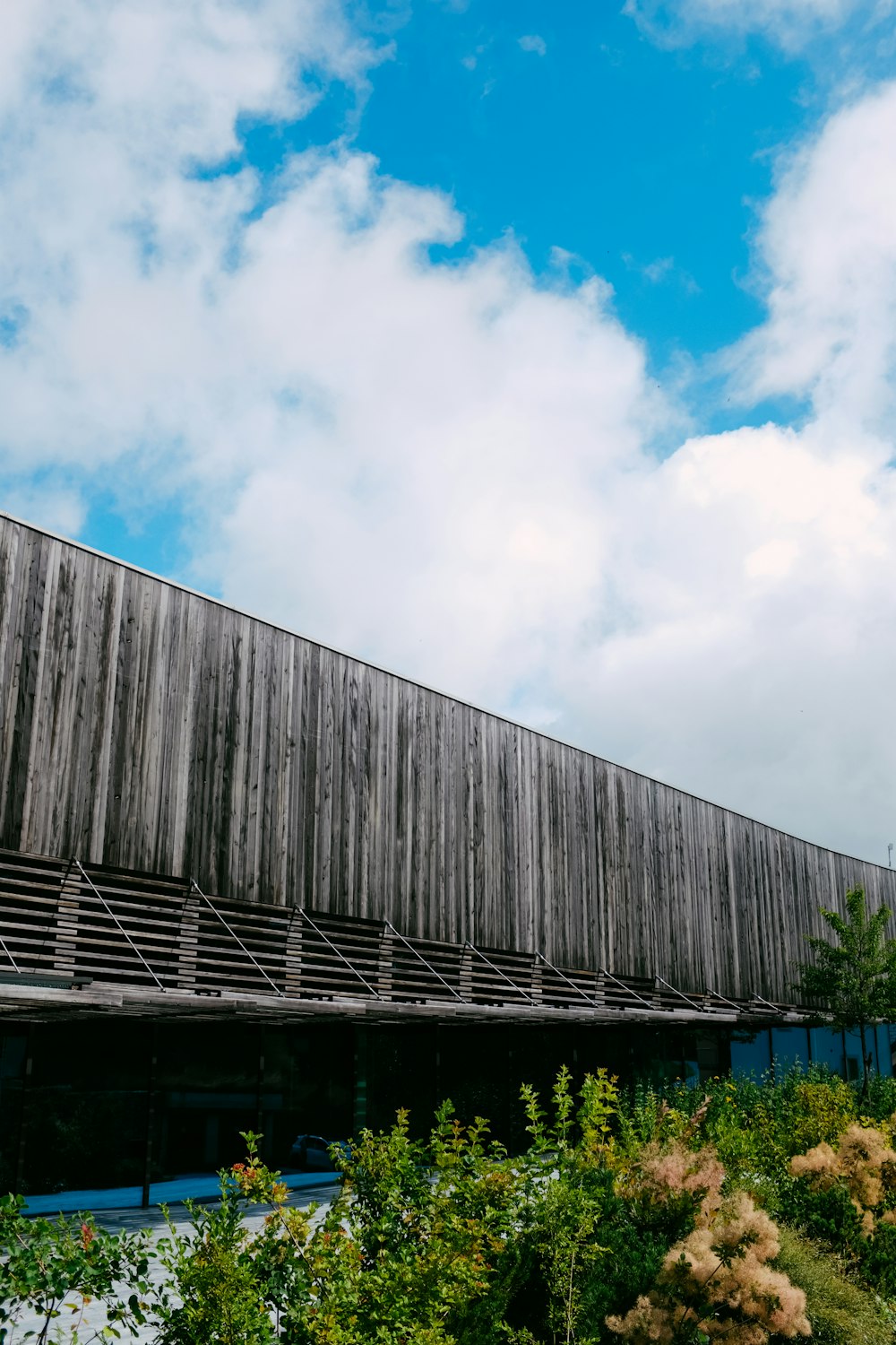 a wooden building with a blue sky in the background