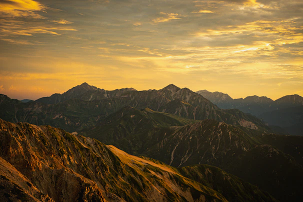 A vibrant sunset casting golden hues over the majestic peaks of Hunza Valley.