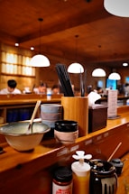 A cozy restaurant counter with colorful bowls of rice balls and chopsticks ready to serve.