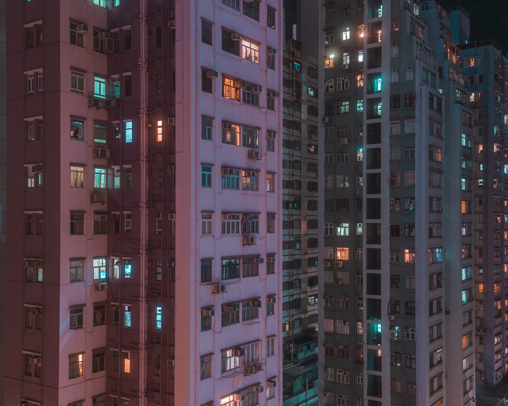 a group of tall buildings lit up at night