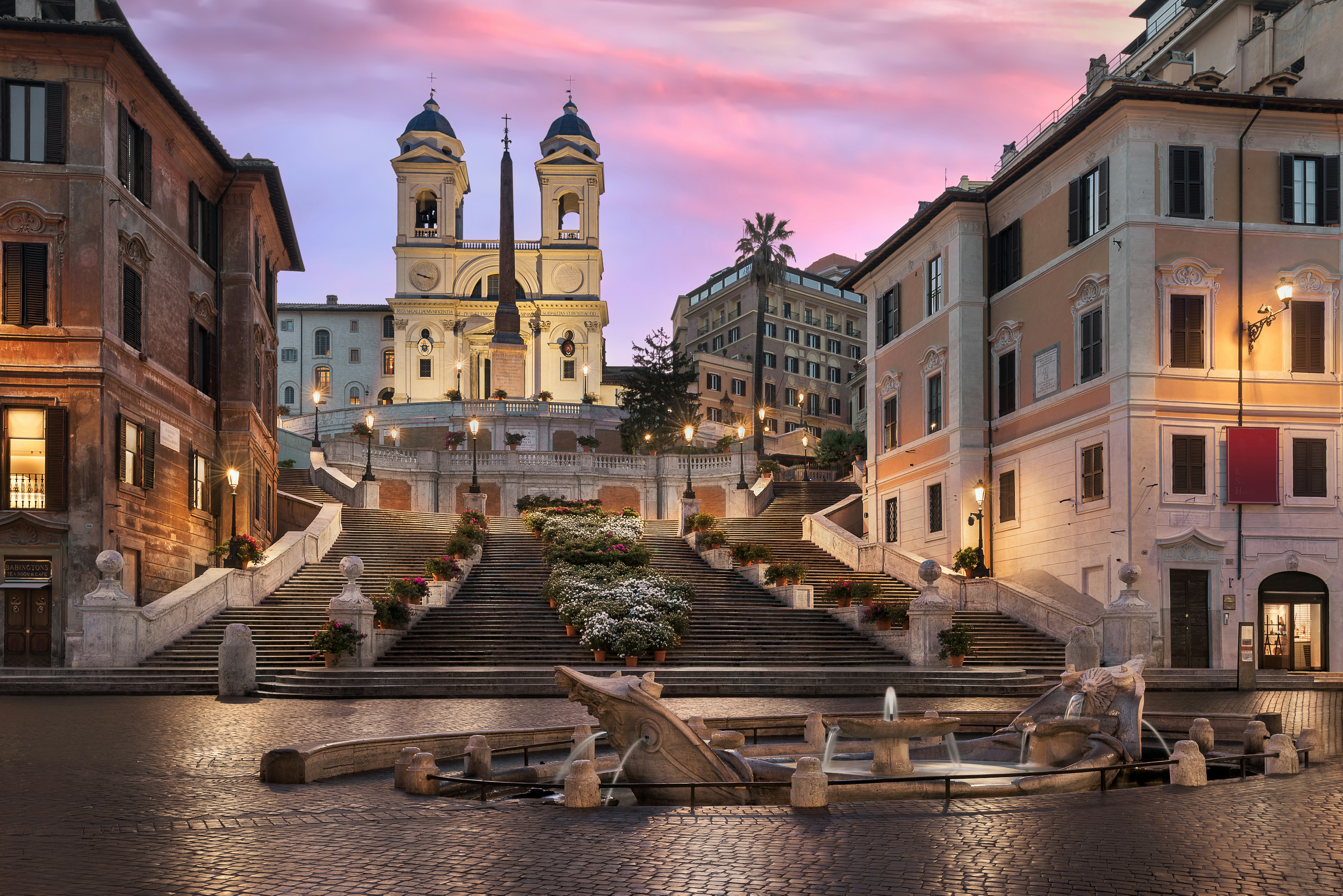 a large building with a steeple and a fountain in front of it