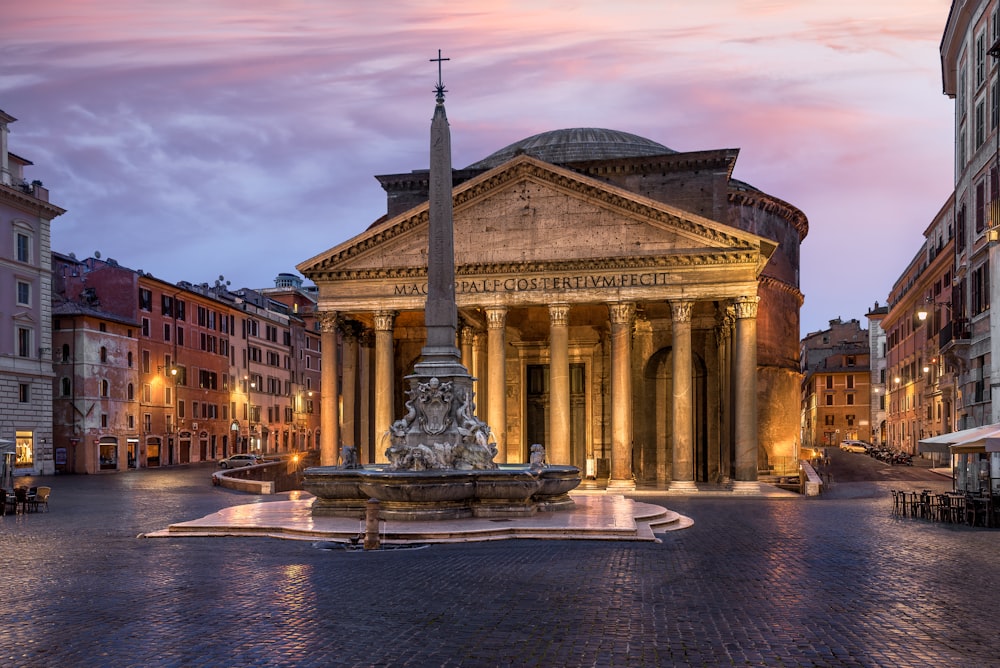 a large building with a fountain in front of it