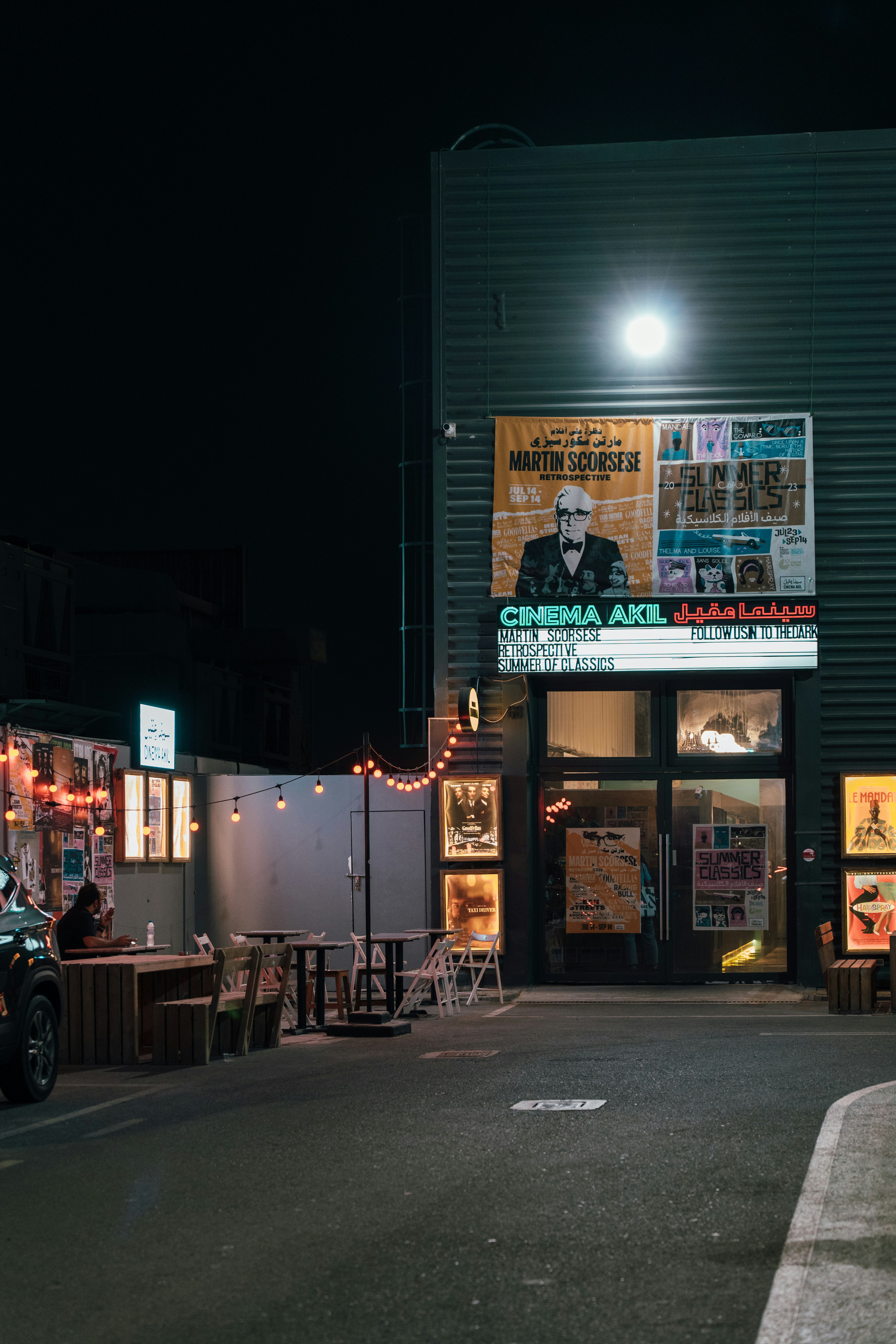 a dark street with a motorcycle parked in front of a building