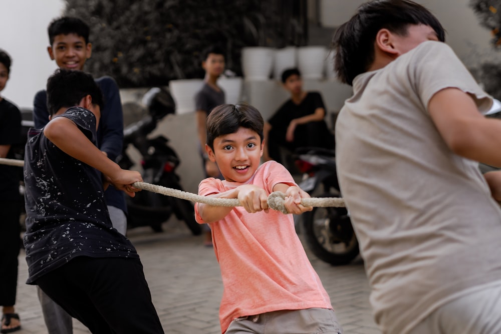 a group of people playing tug of war