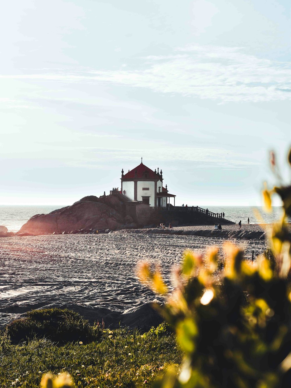 a light house sitting on top of a hill next to the ocean