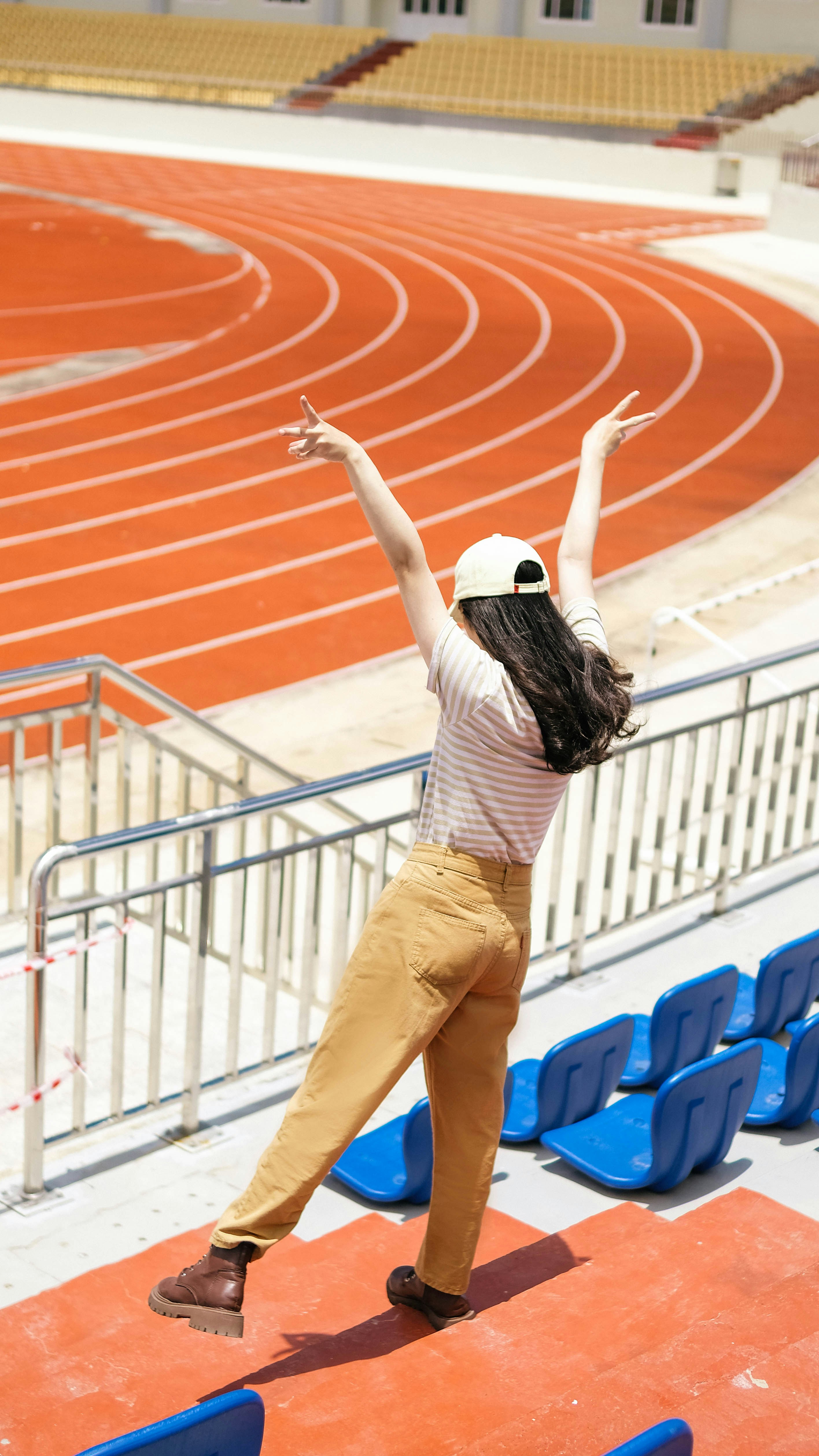 a woman is jumping in the air on a track