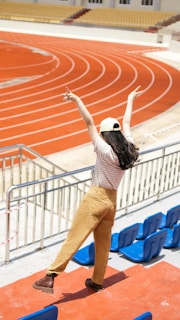 a woman is jumping in the air on a track