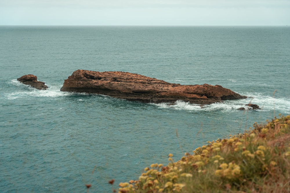 a rock outcropping in the middle of the ocean