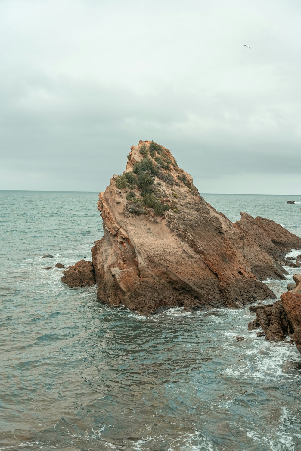 a rock outcropping in the middle of the ocean