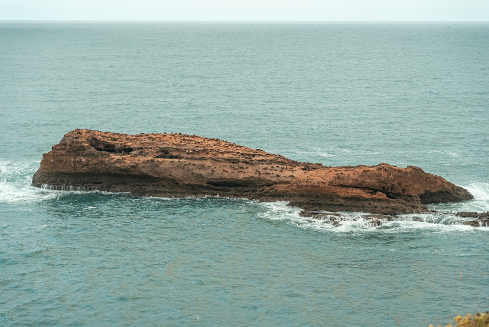 a rock outcropping in the middle of the ocean