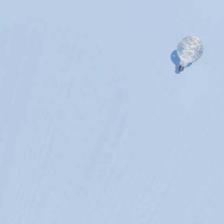 a kite flying in the sky on a clear day