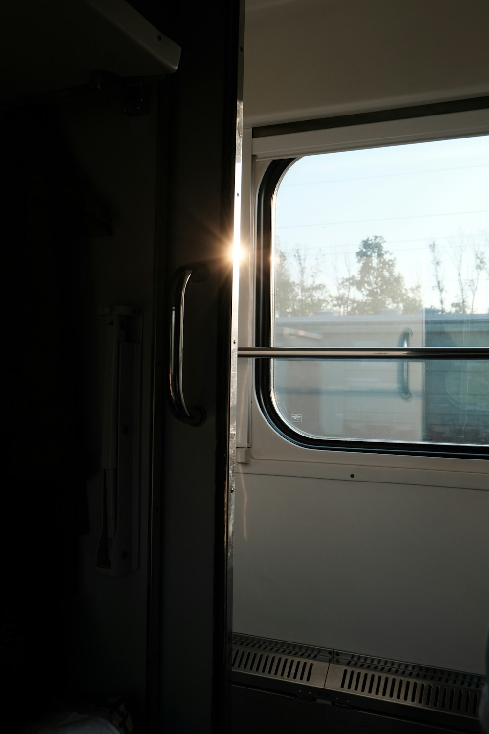 the sun is shining through the window of a train