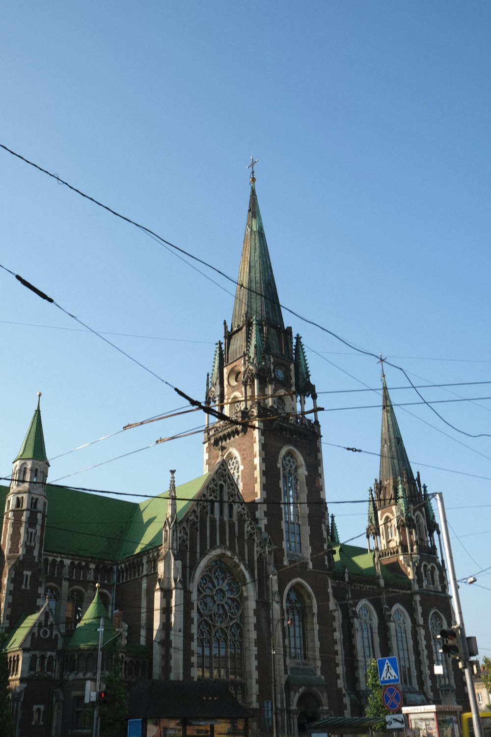 a large church with a green roof and steeple