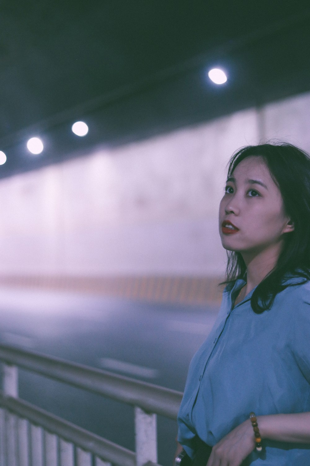 a woman standing in front of a train