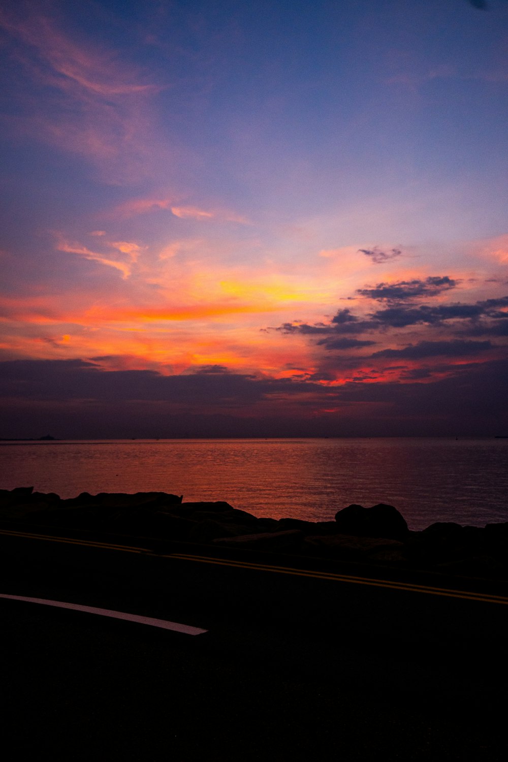 the sun is setting over the ocean and the water