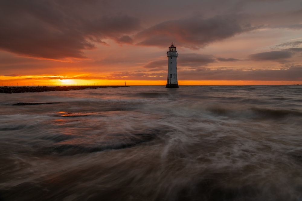 a lighthouse sitting on top of a body of water