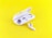 A pair of white wireless earbuds are placed on a vibrant yellow background. One earbud is seated inside an open charging case, while the other rests outside, displaying its speaker mesh.