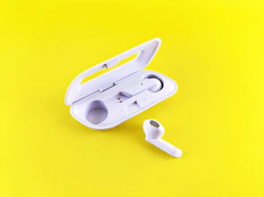 A vibrant set of colorful wireless earbuds resting on a clean white surface.