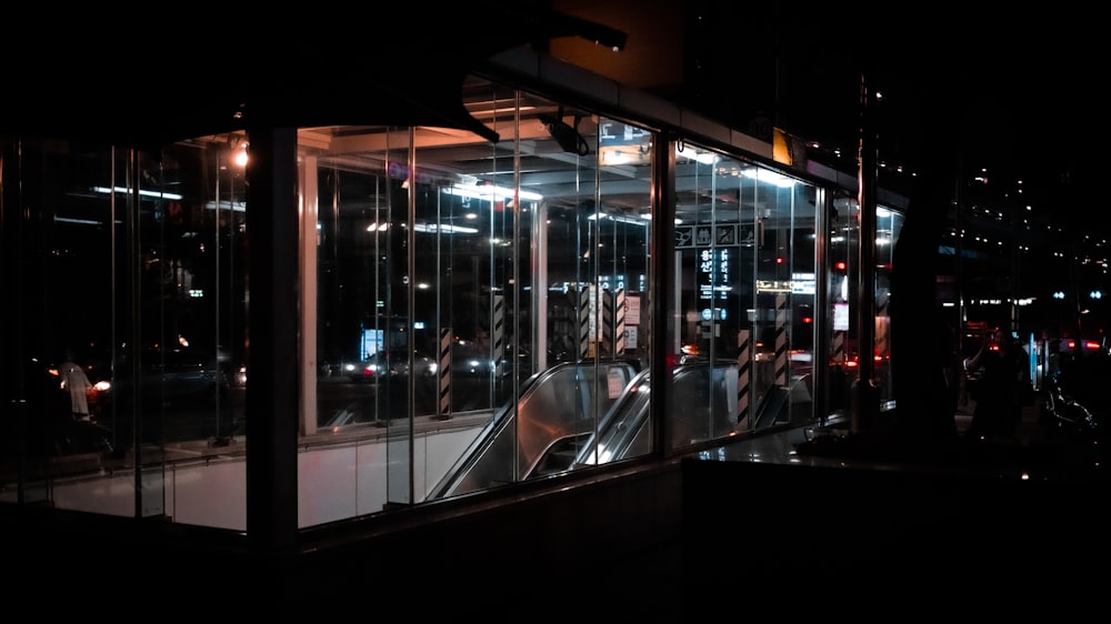 an escalator at night with a lot of lights