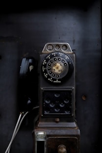 an old fashioned phone sitting on top of a table