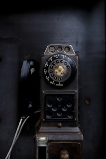 an old fashioned phone sitting on top of a table