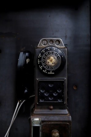 an old fashioned phone sitting on top of a table