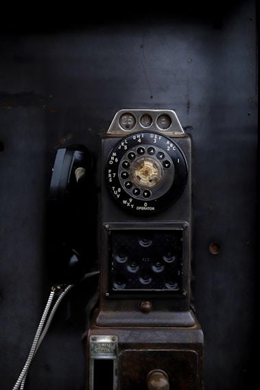 an old fashioned phone sitting on top of a table