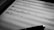 A close-up of a sheet of music featuring handwritten musical notations on lined paper. A pen lies at the bottom of the image, suggesting the act of composing or annotating music.